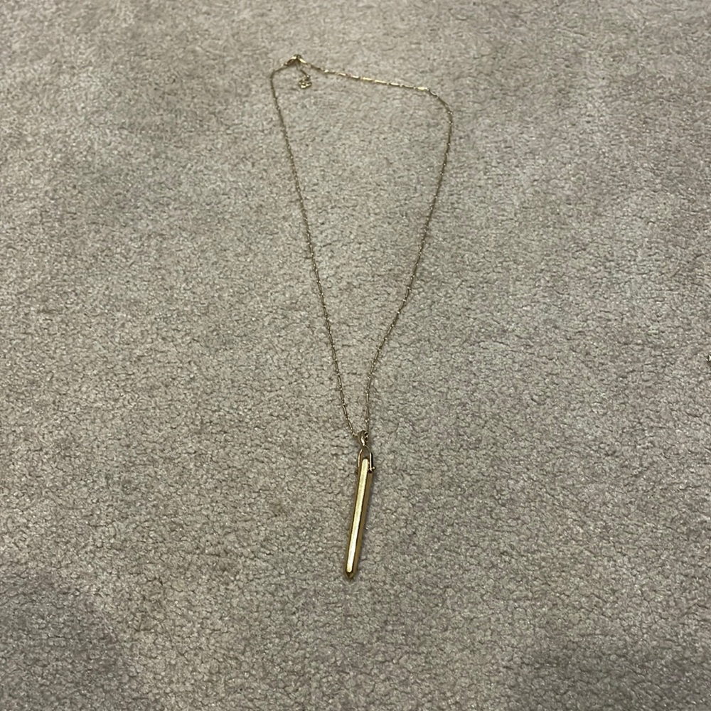 Gold Kendra Scott necklace.